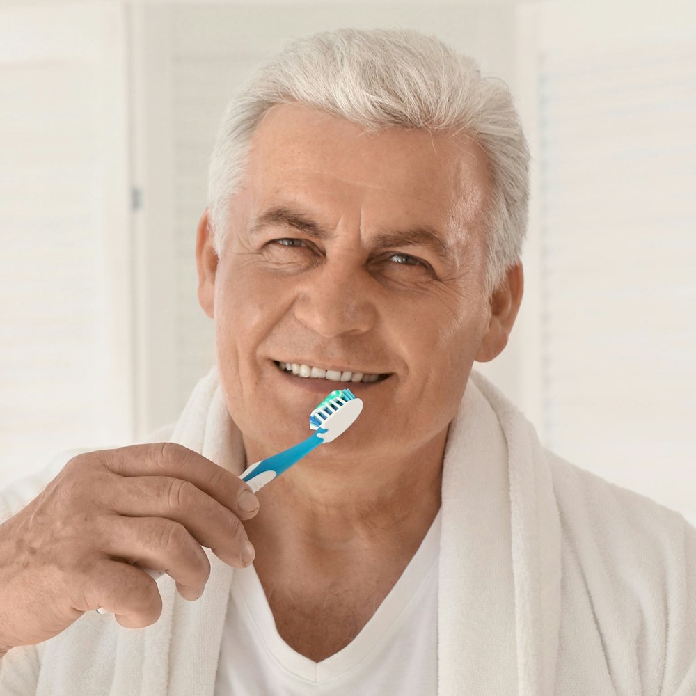 Mature man brushing teeth
