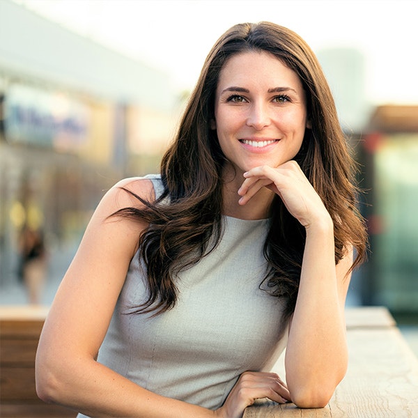 Woman with long hair propping chin up in hand